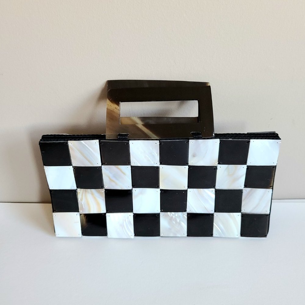 Black and white checkered mother of pearl purse with brown Bakelite handles.